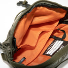 Bravo Co Quarter Block 1 Ripstop Olive opened to display the bright orange interior, microfiber-lined compartment, and internal organizer panel for EDC and camera gear.