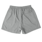 Back view of Cove Charcoal Grey Performance Shorts, made from eco-friendly recycled plastic bottles. Designed with a 5" inseam, these athletic shorts feature an adjustable elastic waistband, drawstring, and a zippered back pocket for secure storage. Perfect for gym, swim, or lounging, they offer a comfortable, flexible fit with moisture-wicking and quick-dry capabilities.