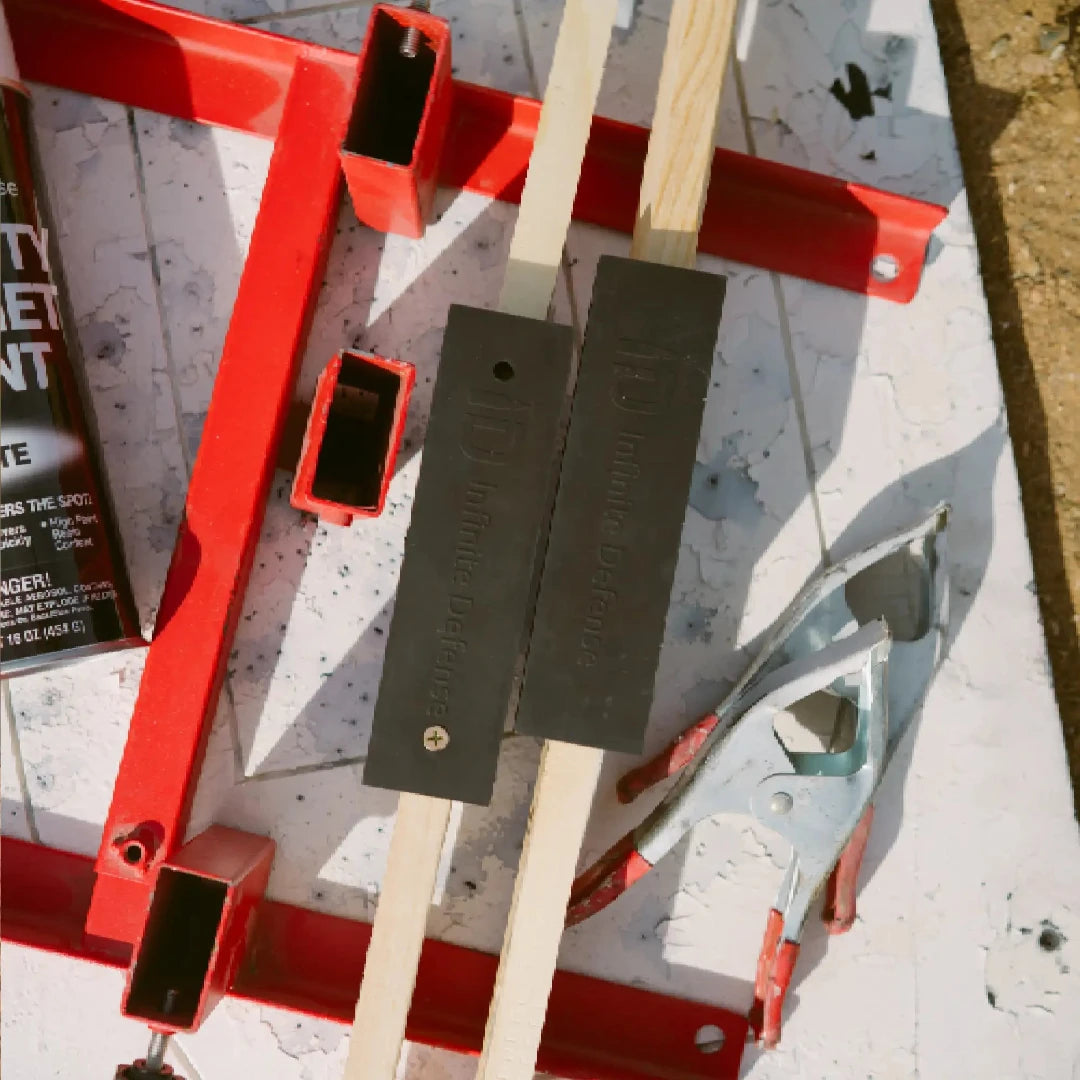 Red metal stand with wooden handles on a textured surface