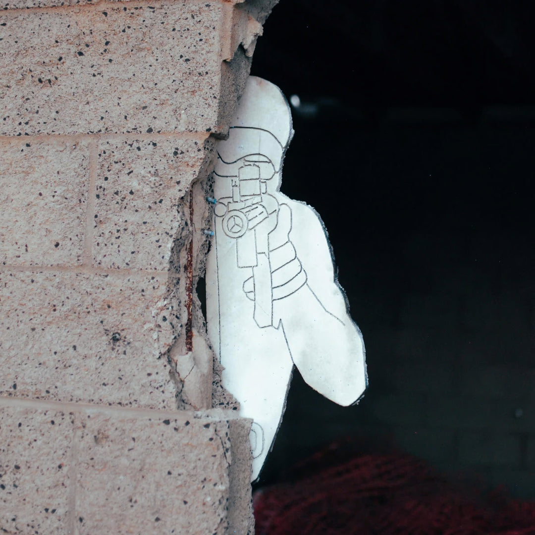 white silhouette target hiding behind a brick wall