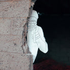 white silhouette target hiding behind a brick wall