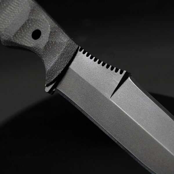 Close up of Dynamis x Winkler DYNAMIS double edge 80CRV2 combat knife showing blade grind and precision thumb ramp jimping