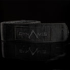 Close-up of the Dynamis Alliance LOPRO Belt black logo patch and reinforced nylon webbing construction.