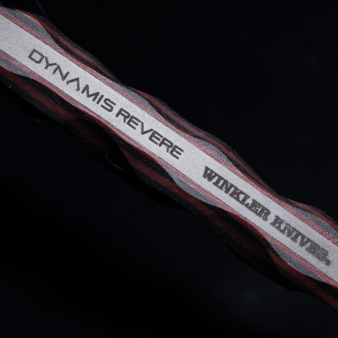 Close up of Dynamis Alliance x Winkler Knives collaboration branding etched on double-edged 80CRV2 combat knife blade