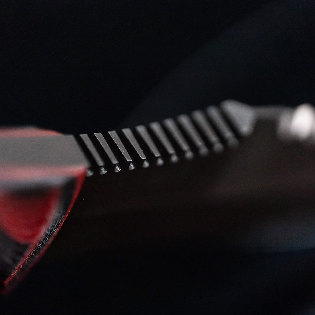 Close up of Dynamis Alliance Revere combat knife thumb ramp on 80CRV2 double-edged blade for enhanced grip control