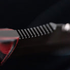 Close up of Dynamis Alliance Revere combat knife thumb ramp on 80CRV2 double-edged blade for enhanced grip control