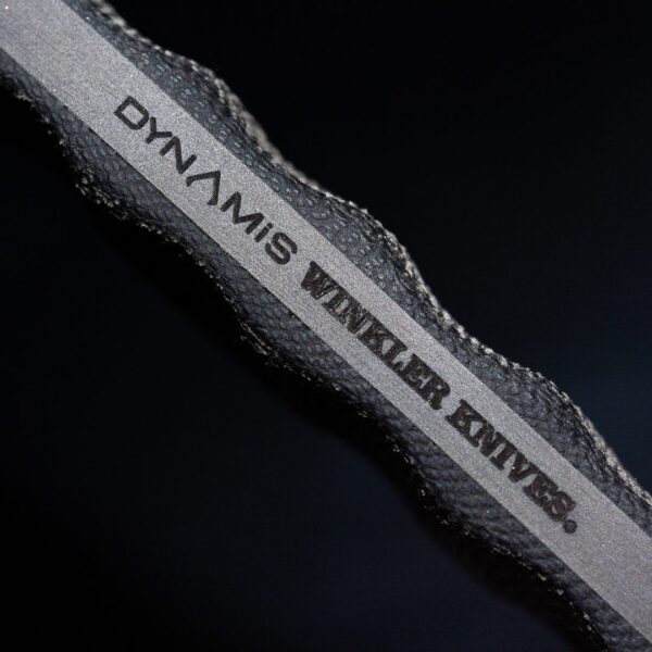 Close up of Dynamis Alliance x Winkler Knives co-branded DYNAMIS double edge combat knife etched on 80CRV2 steel blade