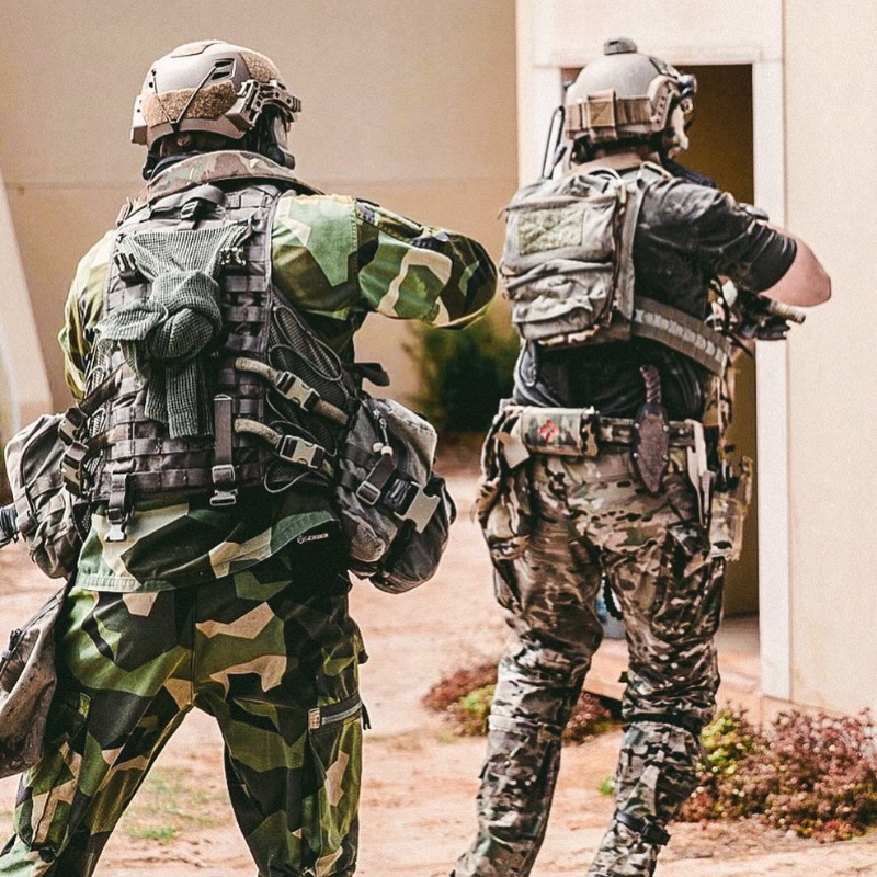Operators wearing plate carriers with Ferro Concepts Back Panel Double Pouch demonstrating expanded rear storage and modular loadout capability