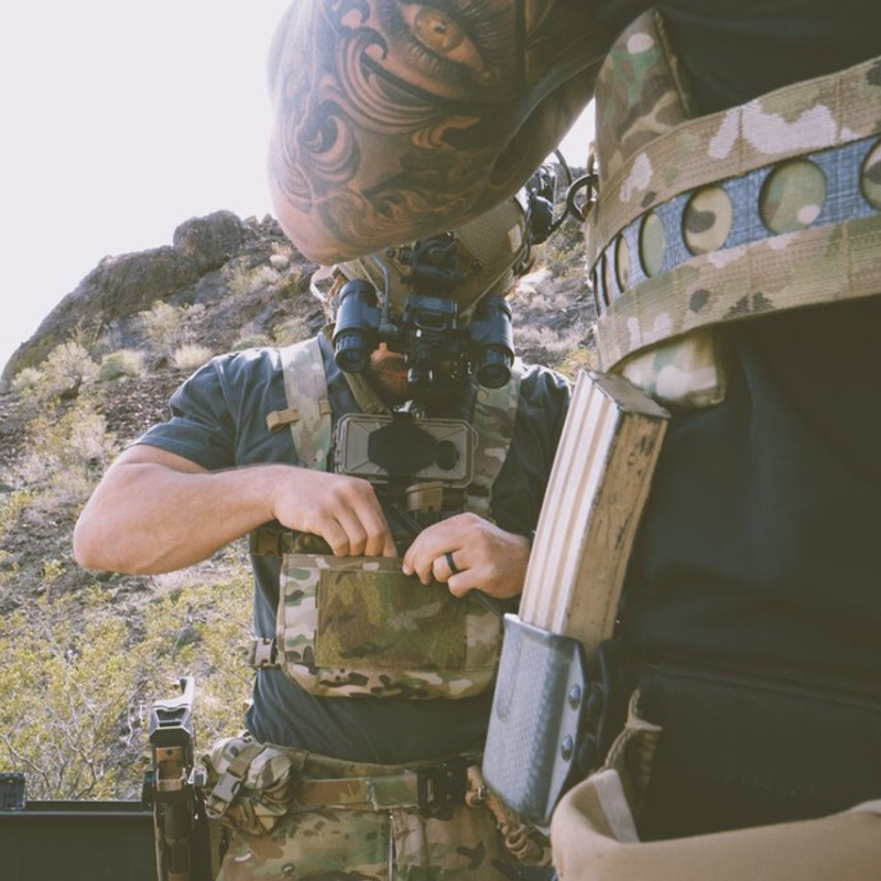 User operating a rifle while wearing a Ferro Concepts Chesty Rig Mini Harness configured for tactical training and mission-specific gear carry.