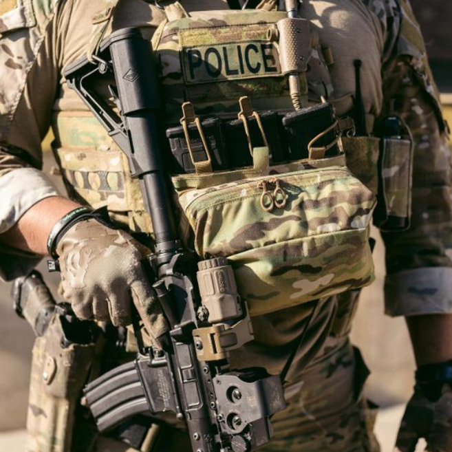Photo showing the Ferro Concepts FCPC V5 Base Plate Carrier actively used in a combat scenario highlighting secure fit, modular MOLLE panels loaded with mission-critical gear, and durable construction that provides protection and mobility. Trusted by operators and tactical professionals for high-threat missions and battlefield conditions.