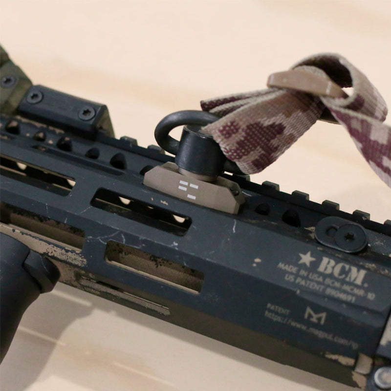 In-use image of the Ferro Concepts M-LOK QD Sling Mount mounted to a rifle’s Magpul M-LOK handguard with a push-button QD swivel attached, demonstrating secure, snag-resistant sling routing for patrol, range, and operational use. Adds near-zero weight to the setup.