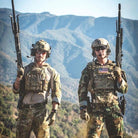 Operators wearing Ferro Concepts The Dangler as part of mission ready plate carrier setup in outdoor environment