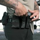 GBRS Group Single Pistol Mag Pouch mounted on belt with shooter accessing magazine during reload
