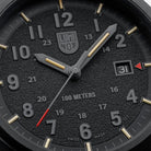 Macro close-up of the Luminox Atacama Field 1961 dial, highlighting the textured blackout face, stealth hour numerals, red arrow date indicator, and red tipped second hand designed for high contrast readability in tactical and outdoor environments.