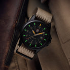 Lifestyle flat lay of the Luminox Atacama Field 1970 watch with the sand NATO strap installed, displayed alongside field gear to highlight its rugged CARBONOX build, desert-inspired dial, and everyday tactical utility for outdoor and adventure environments.