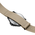 Luminox Atacama Field 1970 watch shown with the sand NATO strap installed, demonstrating how the single-piece webbing securely threads behind and fully covers the stainless steel case back, enhancing comfort, stability, and field-ready durability during outdoor and tactical use.