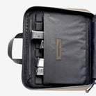 Magpul DAKA Double Pistol Case Flat Dark Earth interior left side featuring eight mag retention bands divider pocket and zippered storage sleeve