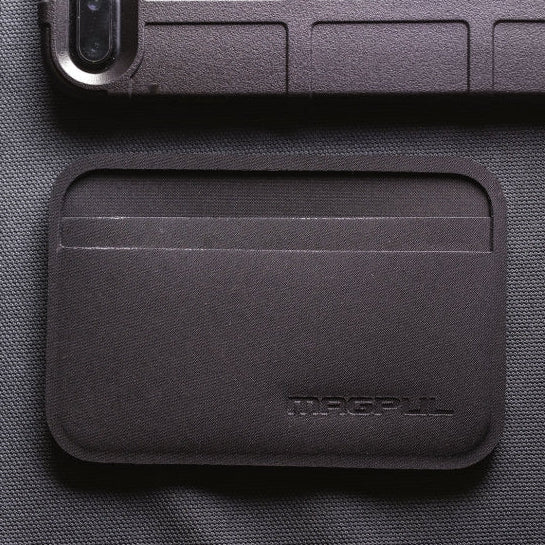 Magpul DAKA Everyday Wallet being used for travel and work showing rear clear ID window and organized card slots for quick identification access