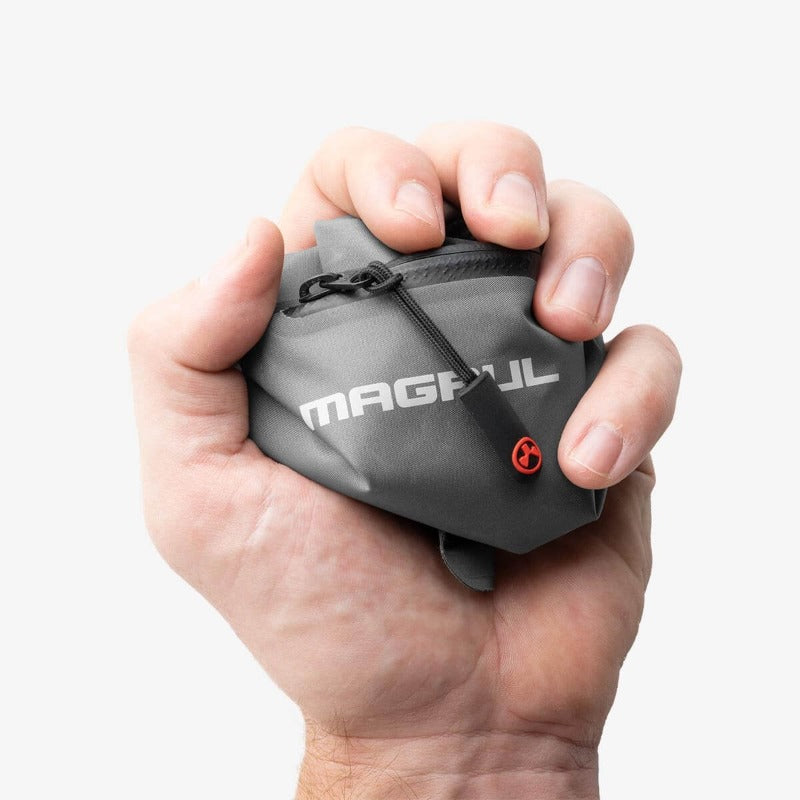 Magpul DAKA Lite Pouch Large Grey compressed in hand demonstrating flexible collapsible storage construction
