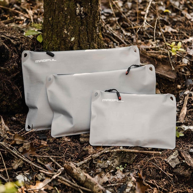 Magpul DAKA Lite Pouch Large Grey filled with cables tools and clothing layers inside backpack for lightweight organization