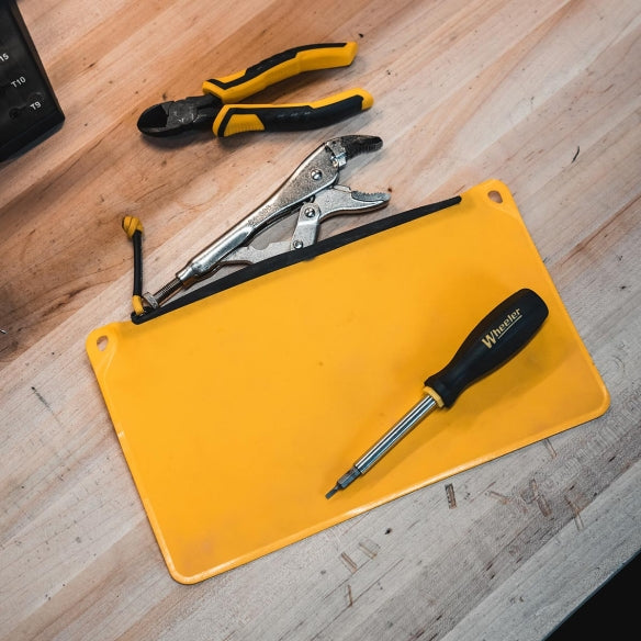 Magpul DAKA Pouch Medium packed with tools on workbench showing rugged waterproof polymer construction ideal for garage storage field repair kits and everyday tool organization