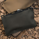 Magpul DAKA Pouch Small OD Green organizing small tools and parts sitting outside highlighting durable polymer waterproof design