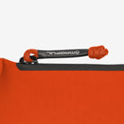 Magpul DAKA Pouch Small Orange close up of water resistant zipper and branded paracord heat shrink pull