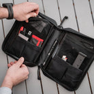 Magpul DAKA Utility Organizer Large Black used as travel admin pouch organizing electronics cables and documents inside backpack