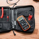Magpul DAKA Utility Organizer Large Black holding tools and small equipment on workbench highlighting durable structured utility storage
