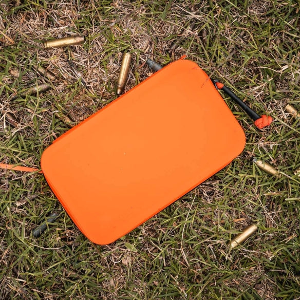 Magpul DAKA Utility Organizer Orange holding small tools and gear in rugged outdoor environment