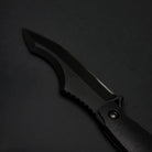 Black fixed blade knife on a dark background