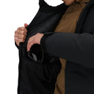 Close-up of the Outdoor Research Allies Colossus II Parka interior pocket being used, showing secure zip storage for essentials inside an insulated extreme cold weather parka designed for Arctic expeditions, military operations, and subzero survival.