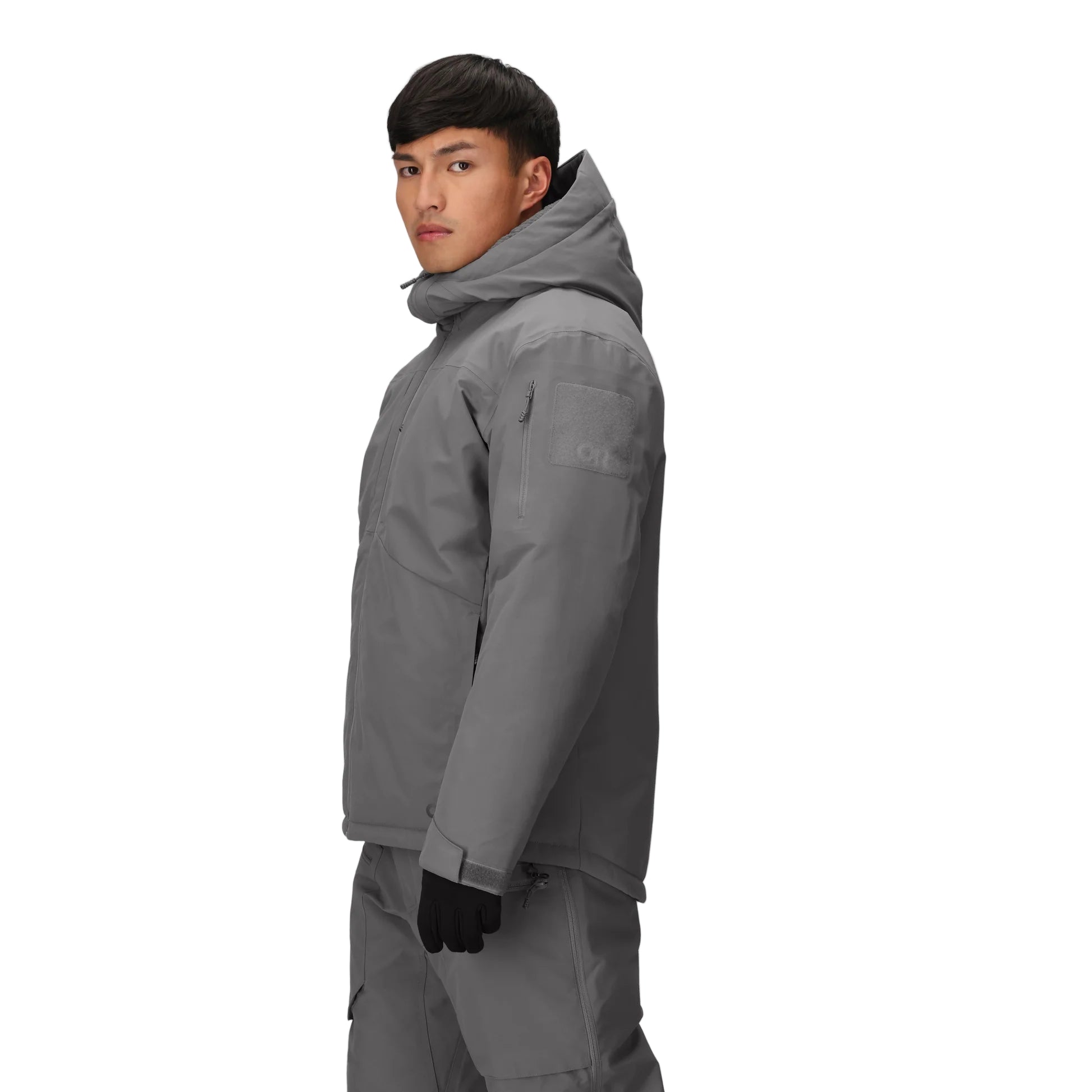 Three-quarter side view of the Outdoor Research Allies Colossus II Parka in Wolf Grey, showing chest and forearm pockets, Velcro® ID patch panel, and durable waterproof shell.