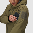 Close up detail of the Outdoor Research Allies Mountain II Jacket in Ranger Green showing the forearm stash pocket, reinforced Cordura ripstop fabric, and waterproof AscentShell tactical construction designed for military, law enforcement, and alpine professionals needing secure storage and extreme weather protection.