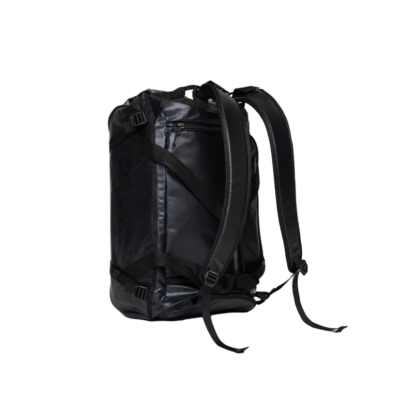 Outdoor Research CarryOut Duffel 40L in Black shown on its side with backpack straps attached | Rugged convertible duffel with 40 liter capacity PU coated 420D ripstop nylon shell compression straps and modular carry design — best black duffel bag with backpack straps for tactical travel missions and outdoor use