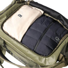 Outdoor Research CarryOut Duffel 40L in Ranger Green shown open and filled with gear | Rugged 40 liter tactical duffel bag made from PU coated 420D ripstop nylon with dirty clean gear divider internal pocket and compression straps — best Ranger Green duffel bag for range gear travel and deployment