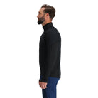 Three-quarter side view of the Outdoor Research Deviator Fleece Half Zip in black, shown on a model with athletic fit, stretch sleeves, and breathable insulation for alpine and fast-paced pursuits.