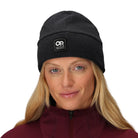 Outdoor Research Polartec 200 Beanie shown worn by a woman | Lightweight recycled Polartec 200 fleece beanie with breathable quick drying fabric UPF 50+ sun protection and helmet compatible low bulk fit — best women’s fleece beanie for hiking trekking tactical missions and cold weather outdoor use