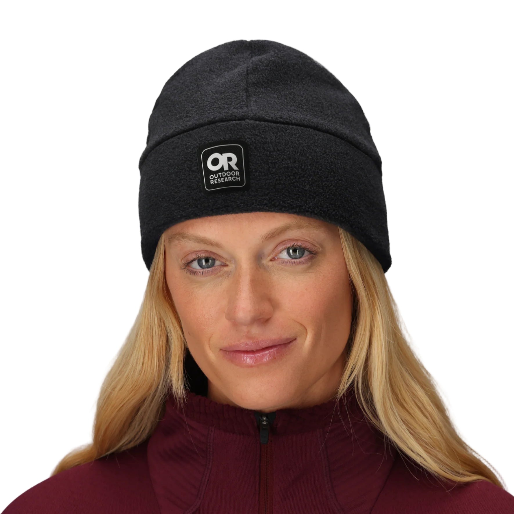 Outdoor Research Polartec 200 Beanie shown worn by a woman | Lightweight recycled Polartec 200 fleece beanie with breathable quick drying fabric UPF 50+ sun protection and helmet compatible low bulk fit — best women’s fleece beanie for hiking trekking tactical missions and cold weather outdoor use