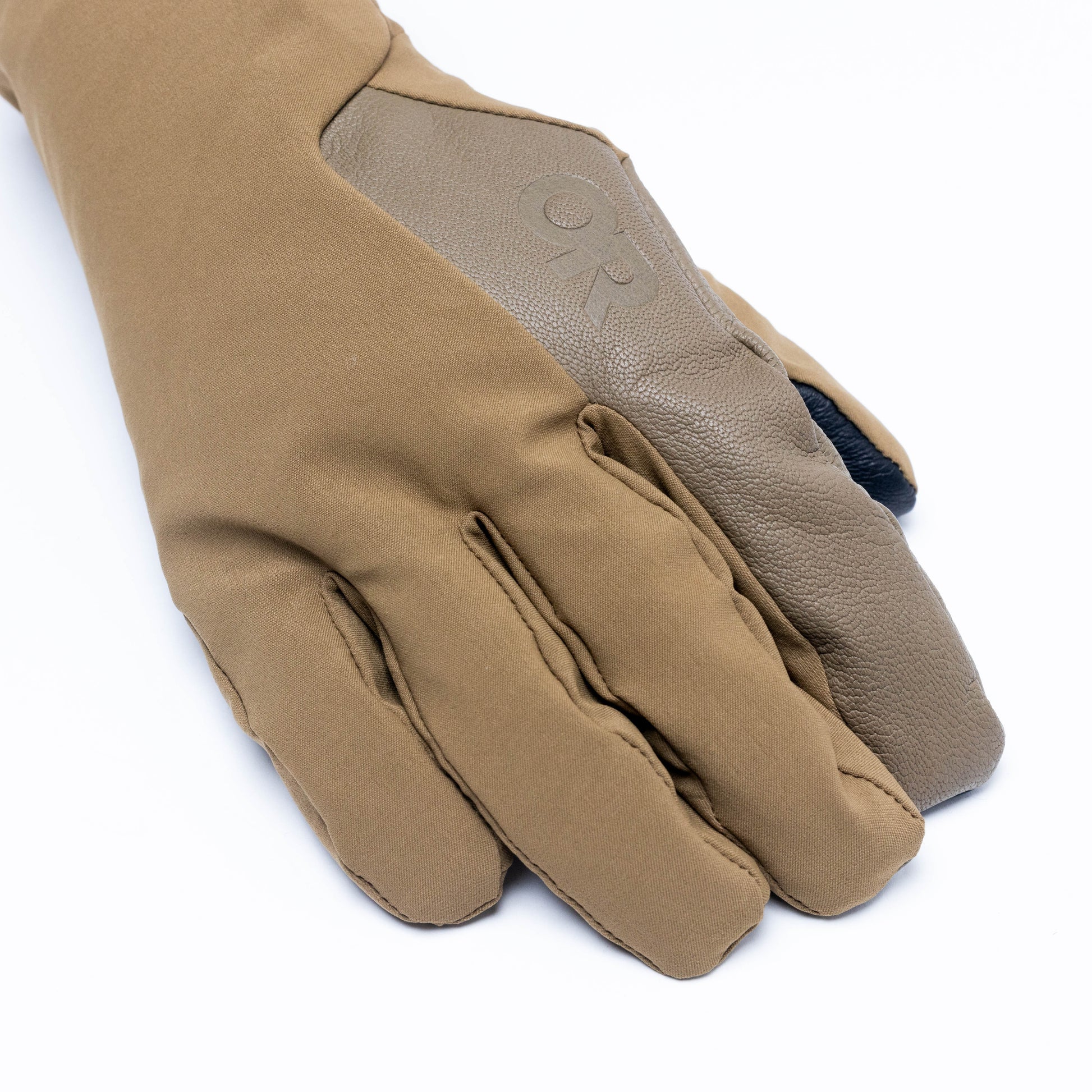 Close-up view of the Outdoor Research Sureshot Pro Gloves in coyote, highlighting reinforced finger construction, touchscreen-compatible tips, and durable back-of-hand design for warmth and dexterity in winter conditions.