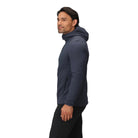 Side view of the Outdoor Research Vigor Plus Fleece Hoodie in Atlantic deep blue, shown on a model to highlight athletic fit, stretch side panels, and ergonomic hood design built for layering and active cold-weather pursuits.