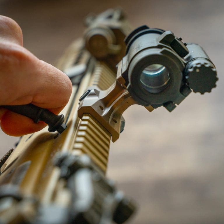 Rear view of the Reptilia DOT Mount mounted on a rifle showing the sight picture down the rail and the lower one third co witness alignment for Aimpoint T1 and T2 style optics.