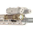Close-up highlighting a weapon light mounted with the Reptilia TORCH M-LOK Light Body on a rifle, showing the active bezel and secure billet-aluminum uni-body interface. Low-profile, snag-resistant M-LOK mount compatible with SureFire M300 Scout and top-mounted aimers for mission-ready weapon lighting.