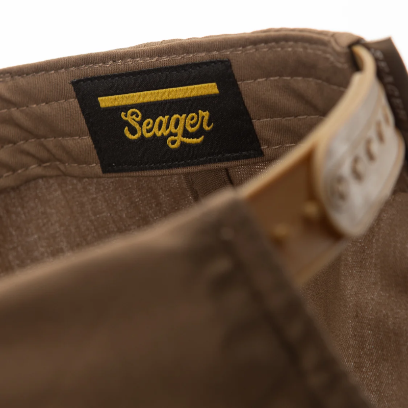 Close-up of a brown fabric with a 'Seager' label on a white background