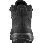 Back and heel view of the Salomon FORCES X Ultra Mid Black showing the reinforced heel counter, tactical non reflective materials, and stability focused Advanced Chassis design built for military use, law enforcement patrol, mountain trekking, and rugged urban operations.