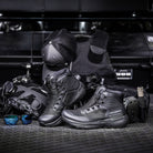 Black Salomon Forces GENESIS FORCES MID tactical mid boots styled in lifestyle flat lay with tactical gear and field equipment, lightweight all terrain military footwear with ripstop upper and Contagrip outsole built for professional duty, range training, and extended operations