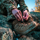 Close-up of Salomon Quest 4D Forces 2 Boots during field preparation, emphasizing durability and tactical functionality.