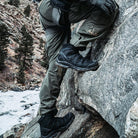 Salomon Quest 4D Forces 2 Boots providing support and traction while moving across rocky and uneven terrain during field operations.
