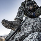 Salomon Quest 4D Forces 2 Boots navigating uneven terrain, highlighting stability, grip, and load-bearing performance.