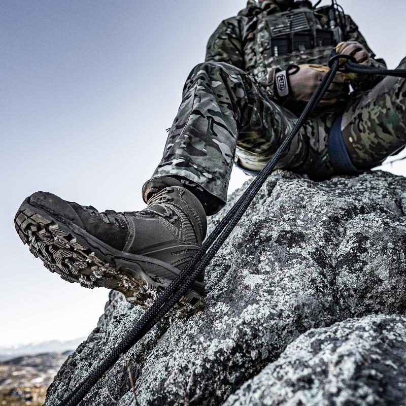 Salomon Quest 4D Forces 2 Boots navigating uneven terrain, highlighting stability, grip, and load-bearing performance.
